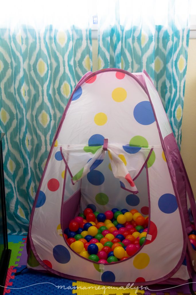 a tent and ball pit in set up as a toddler play space in an office