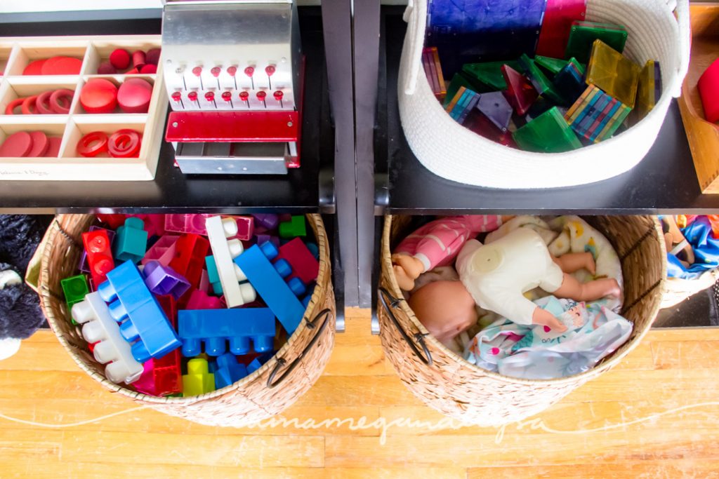 toy shelves with blocks and baby dolls in big wicker baskets