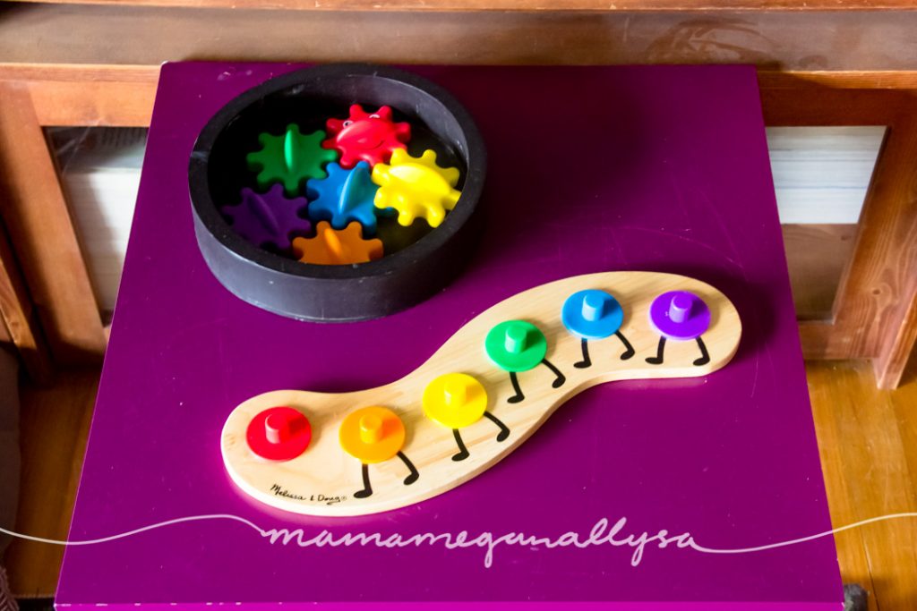 a rainbow caterpillar puzzle on a play table