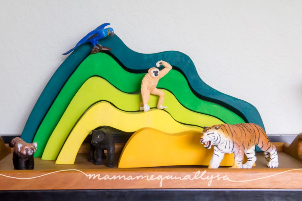 an overview of the homemade hill stacker with her jungle animals staged around it