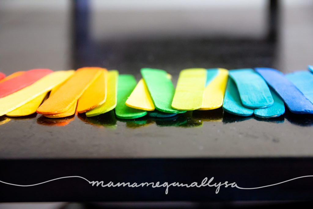 close up of our rainbow hand-painted popsicle sticks for loose parts play