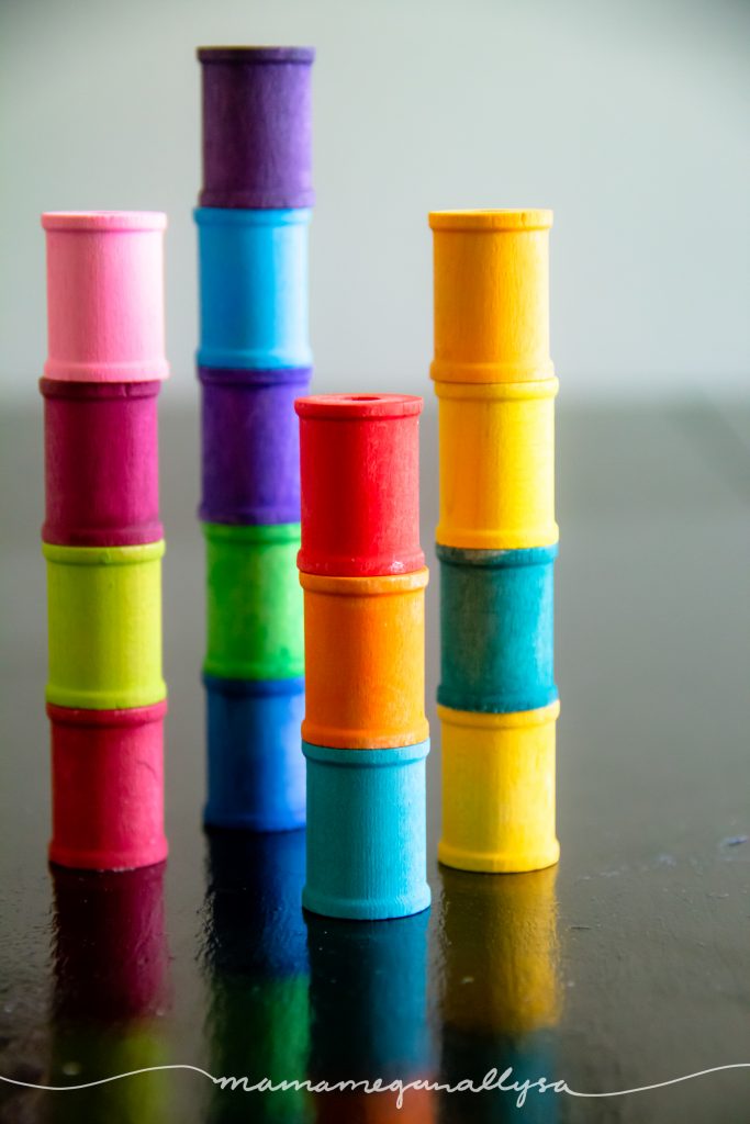 rainbow hand-painted wooden spools stacked up