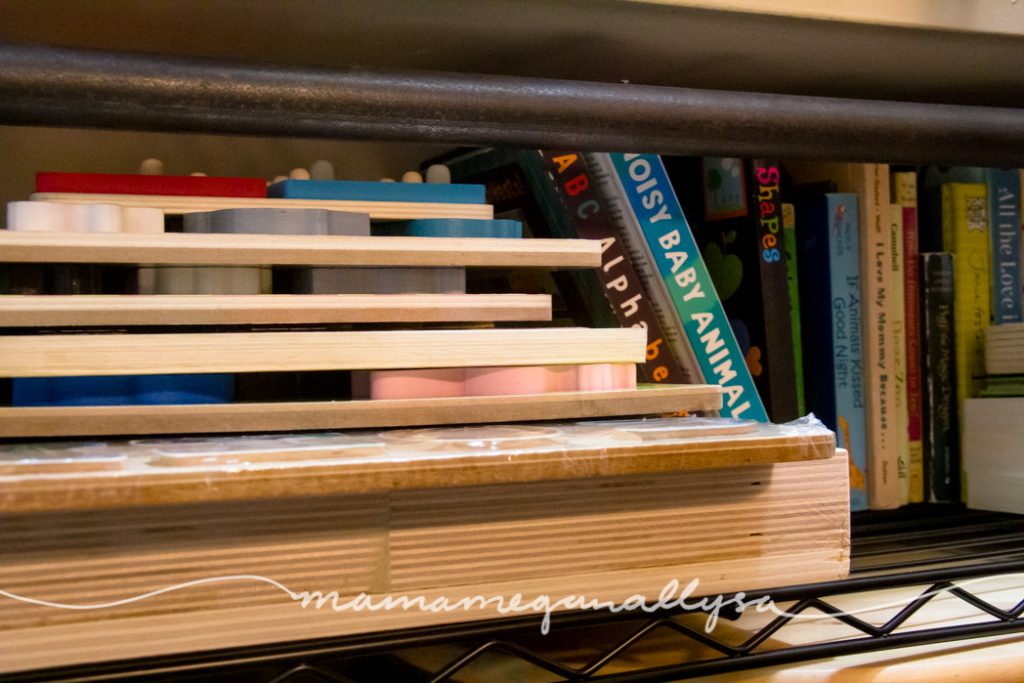 toddler puzzles stacked up next to some board books