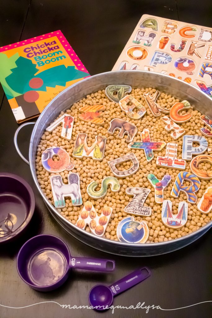 an overview of the ABC's and Chick peas sensory bin, puzzle pieces, the purple bowls and spoon, Chicka Chikca Boom Boom book and the puzzle tray