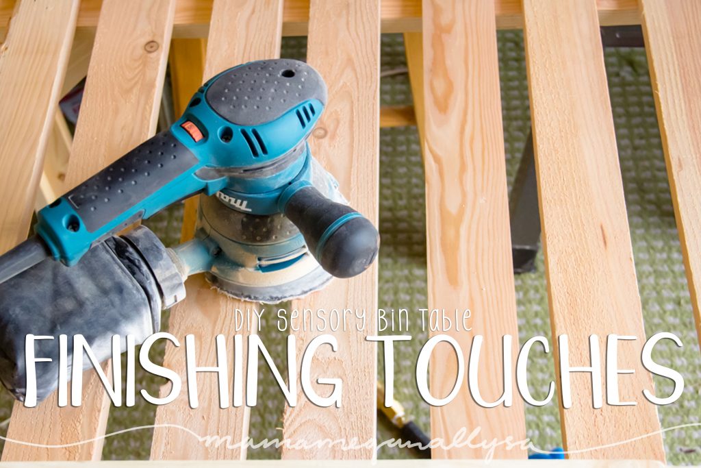 title card for the finishing touches of our DIY sensory bin table showing a power sander sitting on the slats of the table