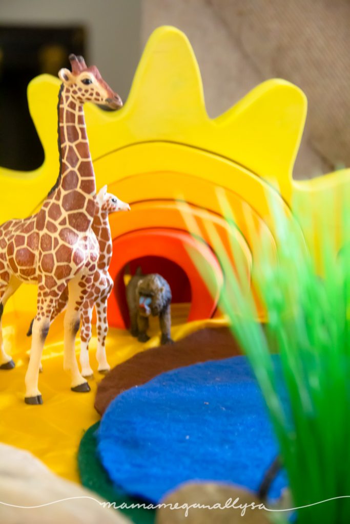 our homemade sun stacker  toy makes a great backdrop for our African Savanna small world set up