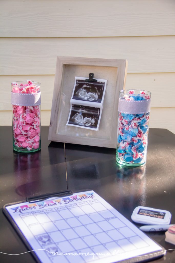 Some of our ultrasound pictures on dysplay with a couple vases full of pink and blue taffy
