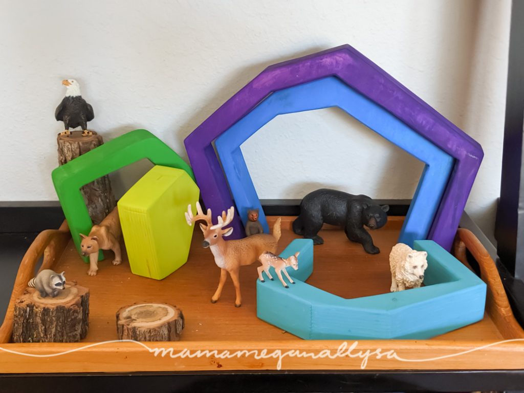 A forest scene set up with some animal figures and our DIY cave stacker. 