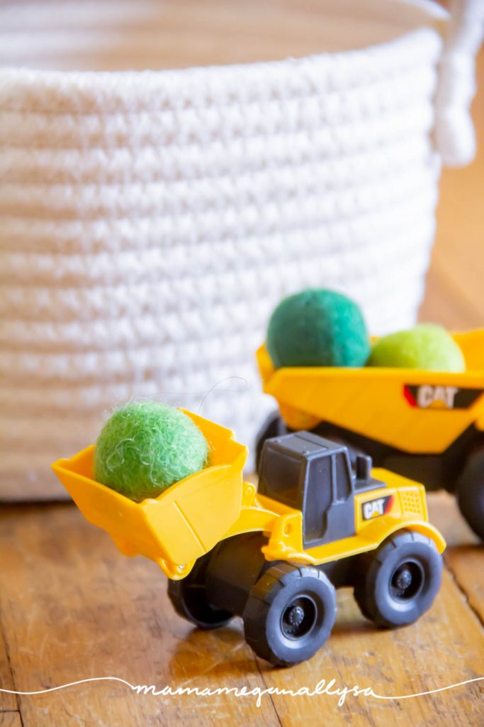 I added some green wool balls to our mini construction trucks so that they would have some "boulders" to work with