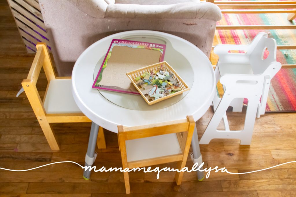 We keep our play table at the end of the couch she will sit there to color, play play dough, and serve her baby dolls food. I keep a puzzle there but it get moved out of the way a lot.