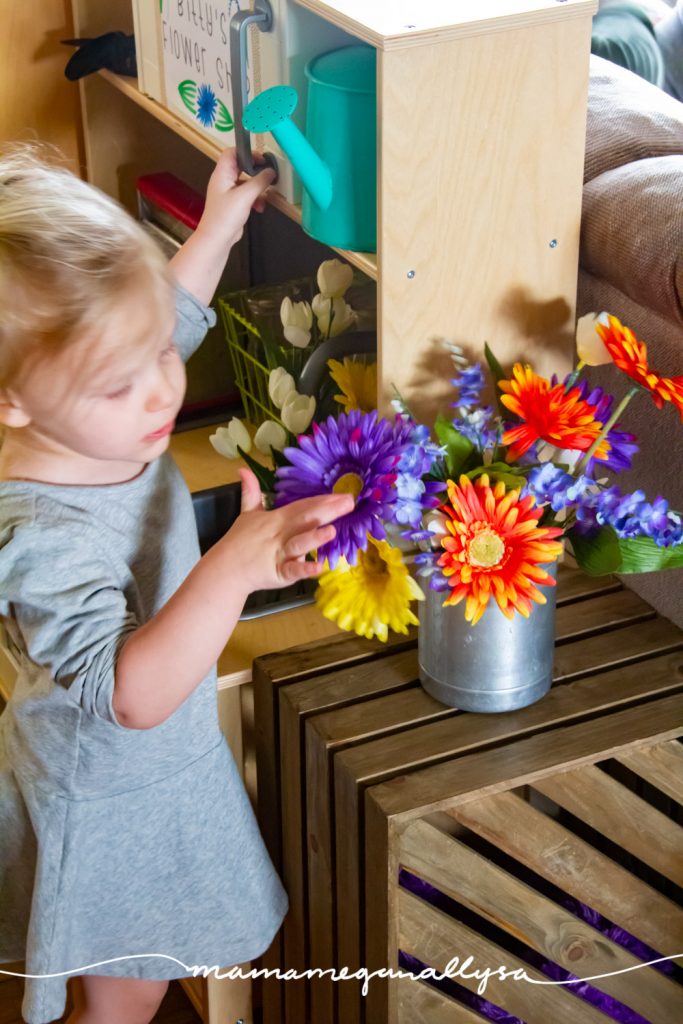 She really enjoys arranging and rearranging the fake flowers in our dramatic play flower shop