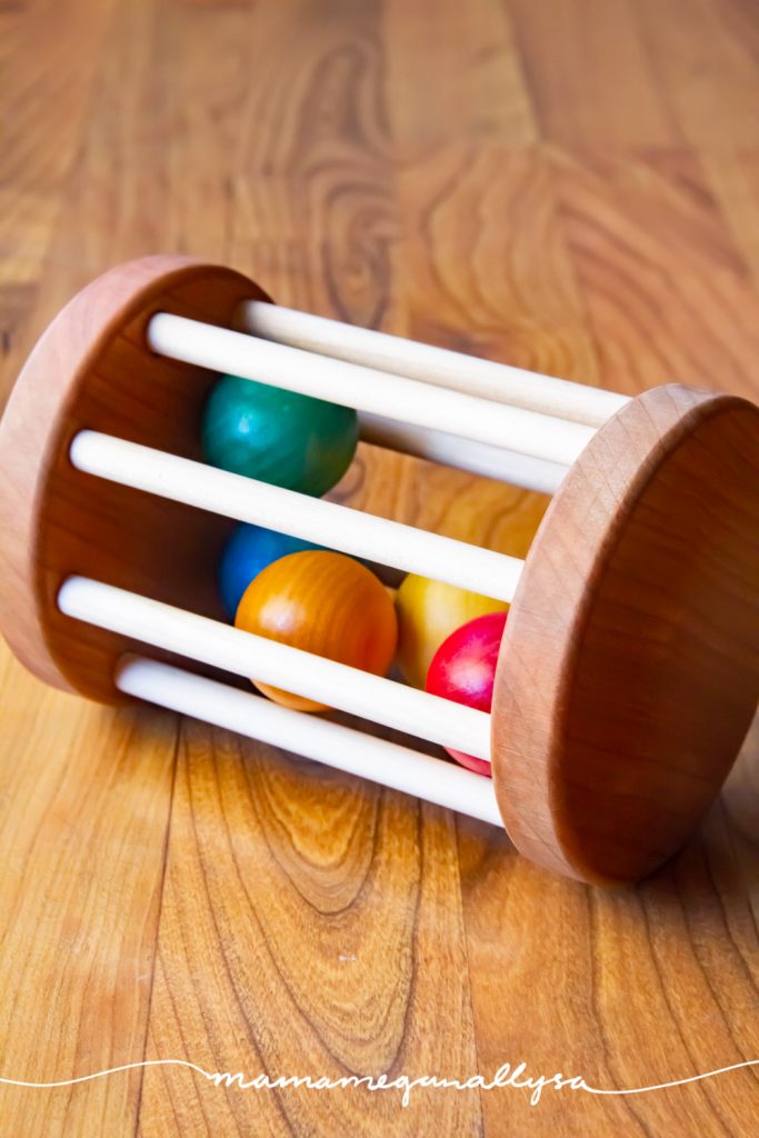 a classic Montessori wooden baby toy that promotes tummy time and crawling.