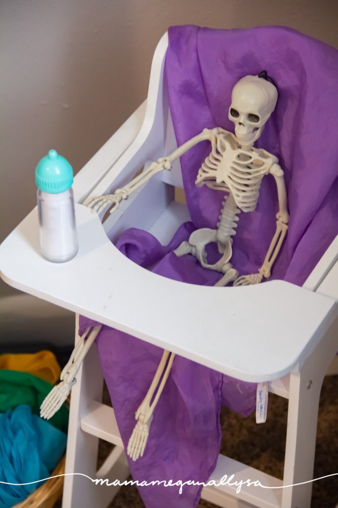 I replace the baby dolls in favor of a little skeleton and it has been a hoot watching them play this week!