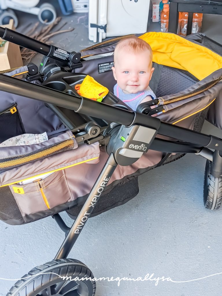 a baby sitting in a brand new stroller wagon