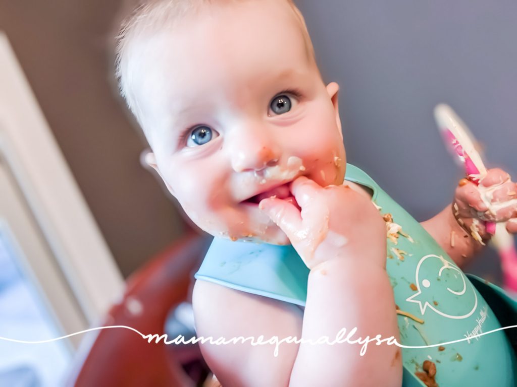 baby with bright blue eyes and a face covered in chili