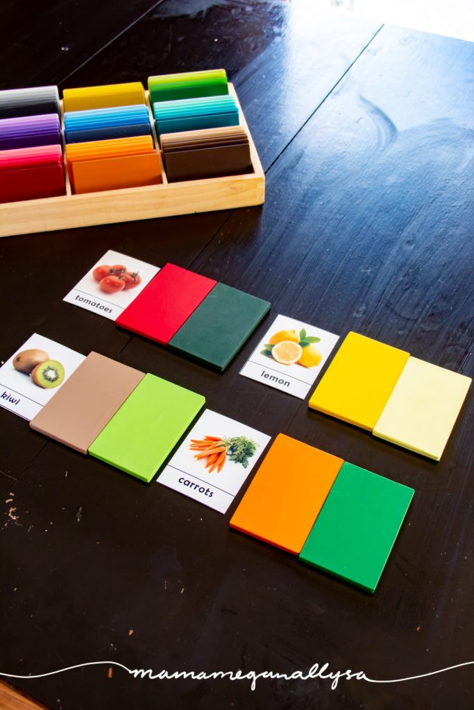 4 3-part-cards with a couple of color tablets next to each, showing the basic colors of the fruit and veggies depicted on the card. with the full set of color tablets in the background