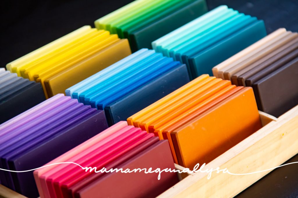 a close up of my DIY Montessori inspired color tablets stored in a wooden divided tray