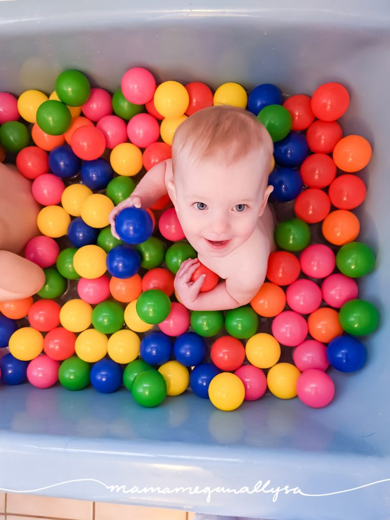 a baby in a bathtub filled with ball bit balls