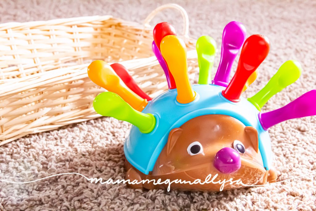 a close up of a plastic hedgehog with removable pegs on his back 