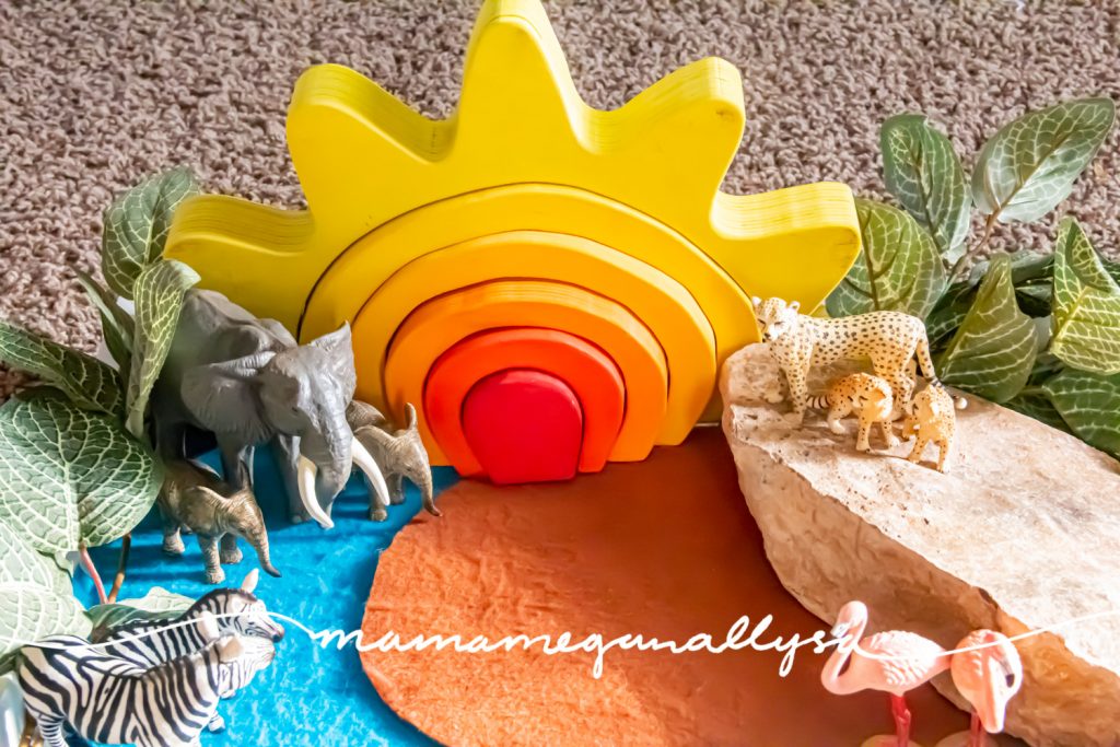 a detail shot of our safari small world with elephants, zebras, cheetahs, and flamingos with my DIY sun stacker