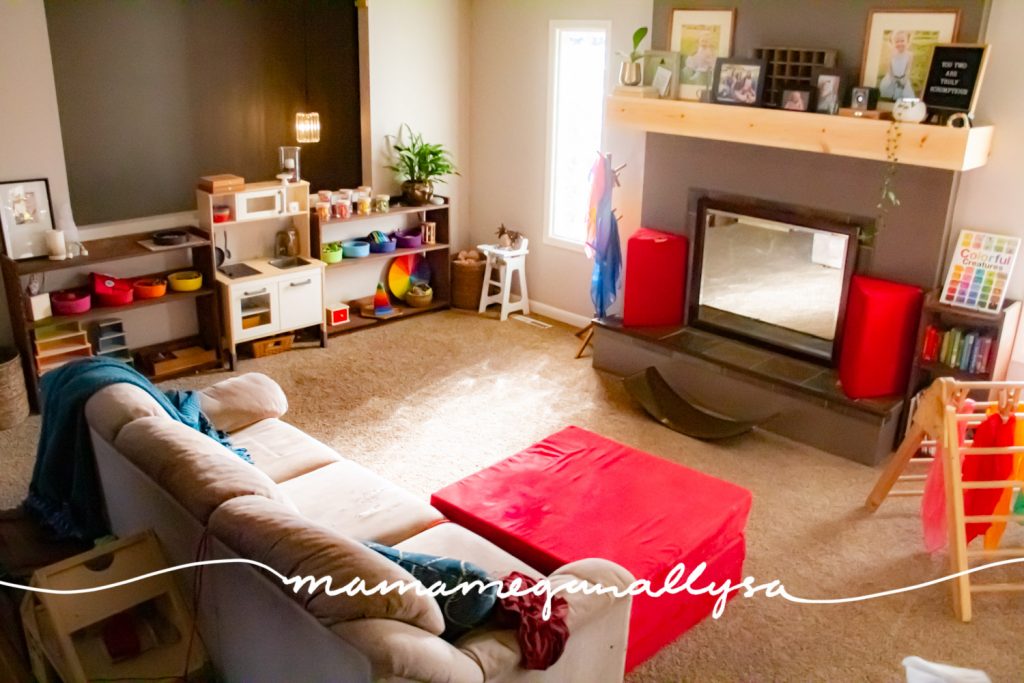 a pulled back overview of our rainbow toy rotation in our livingroom playroom