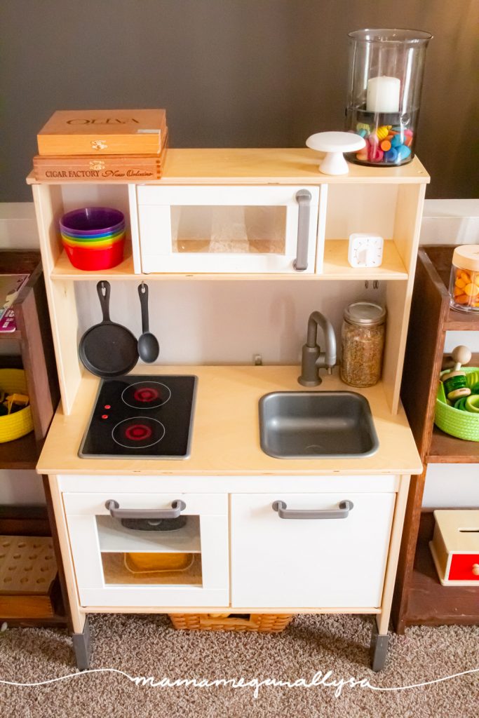 an ikea play kitchen with a few little rainbow touches