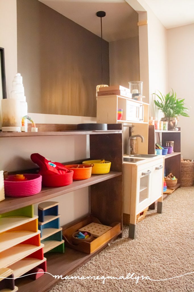 a toy shelf in our livingroom playroom, colorful rope baskets on the second and other rainbow toys on the bottom shelf