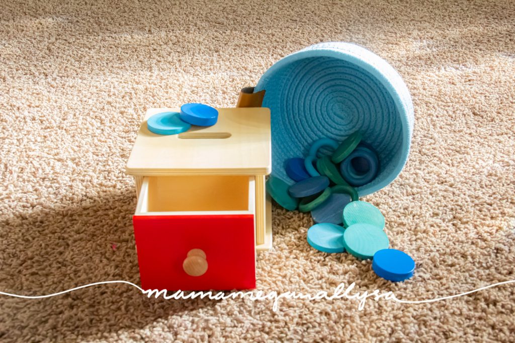 a light blue basket of blue rings and coins for our wooden coin box with red drawer