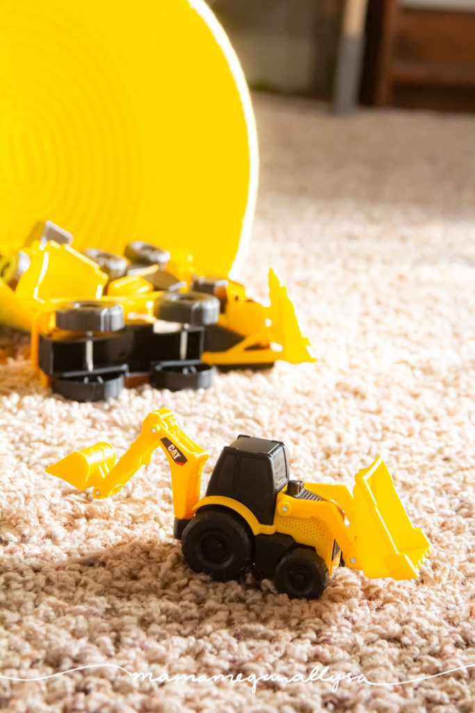 a close up of our mini construction trucks in front of a yellow basket