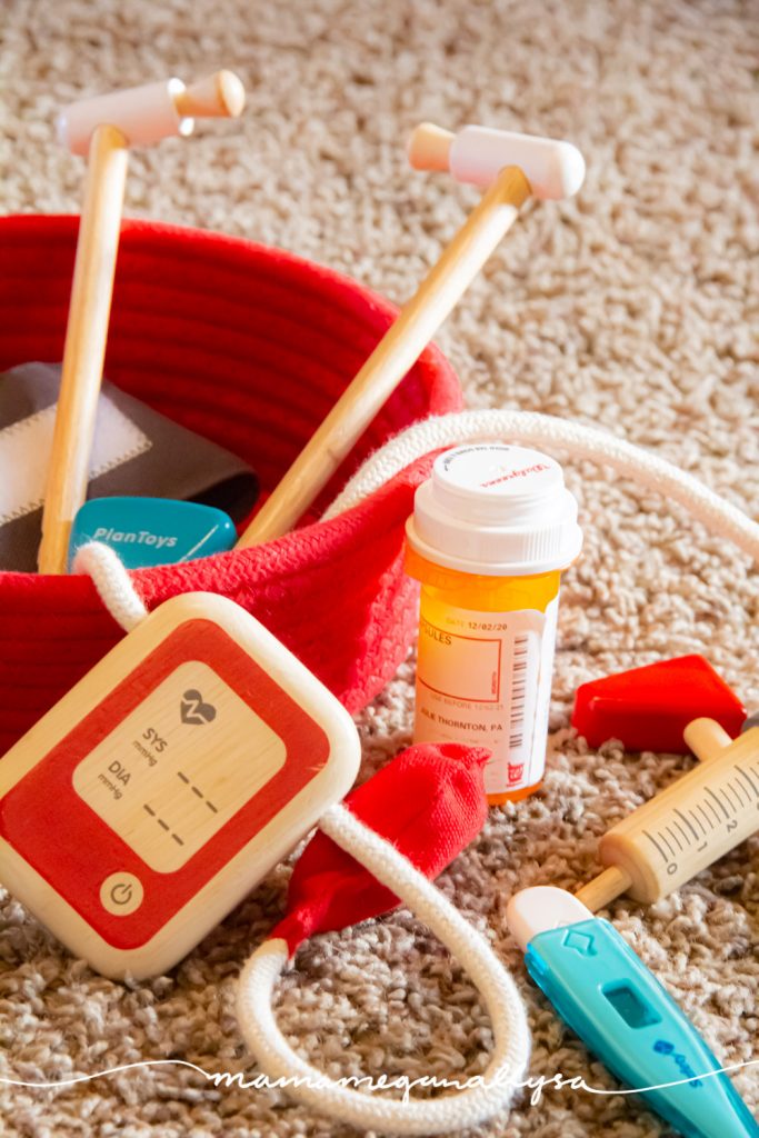 A collection of doctors toys in with a red rope basket