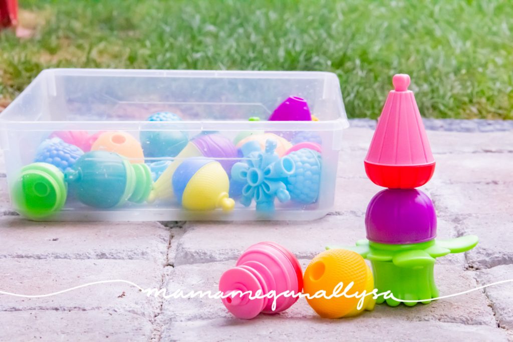 some large colorful plastic lalaboom beads sitting on the patio 