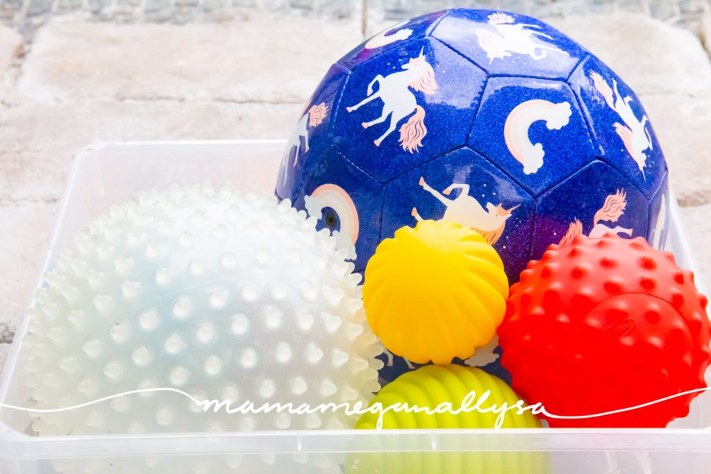 a random selection of balls in a plastic bin