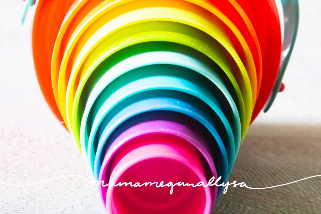 a set of rainbow nesting buckets