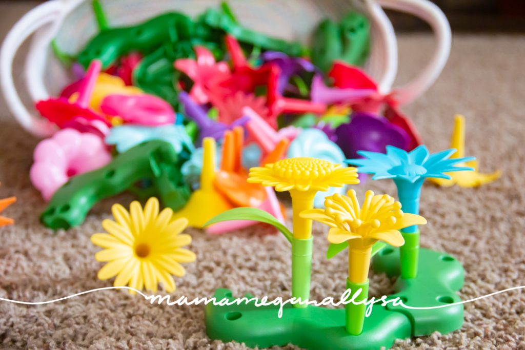 Colorful plastic stacking flowers spilled out of a white rope basket on the floor