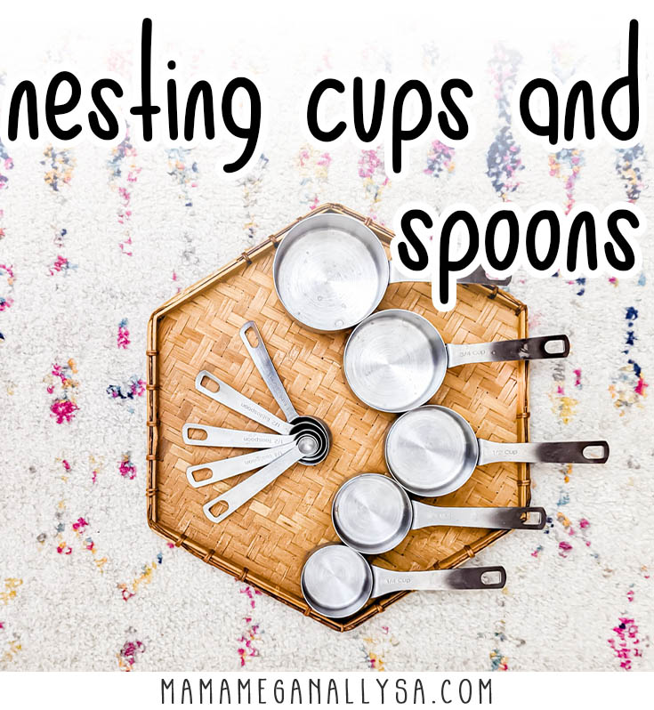 a woven tray that has a set of silver measuring cups and a set of silver measuring spoons on it 