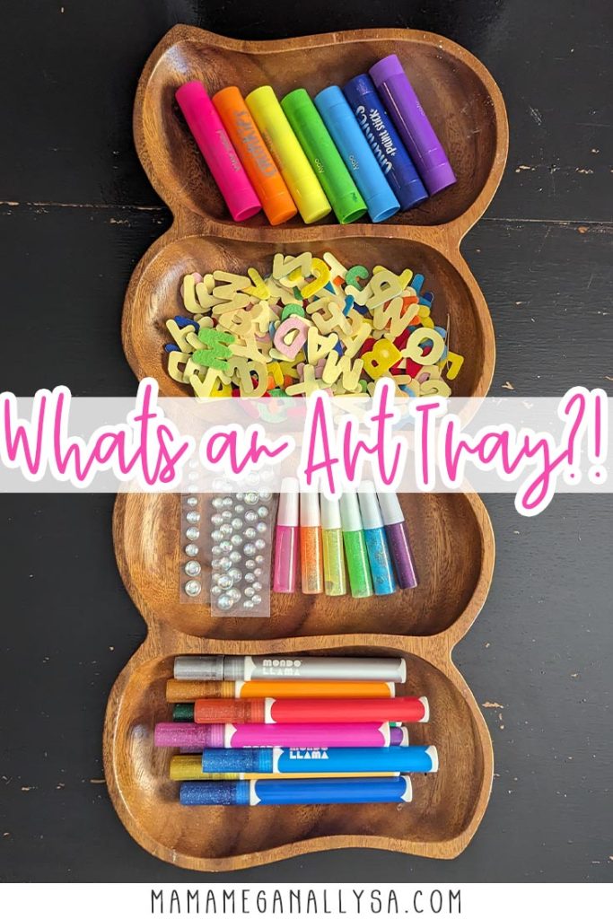 a pin image that reads What's an Art Tray?! with a wooden divided tray sitting vertically on a black table. The tray is filled with a bright selection of art supplies