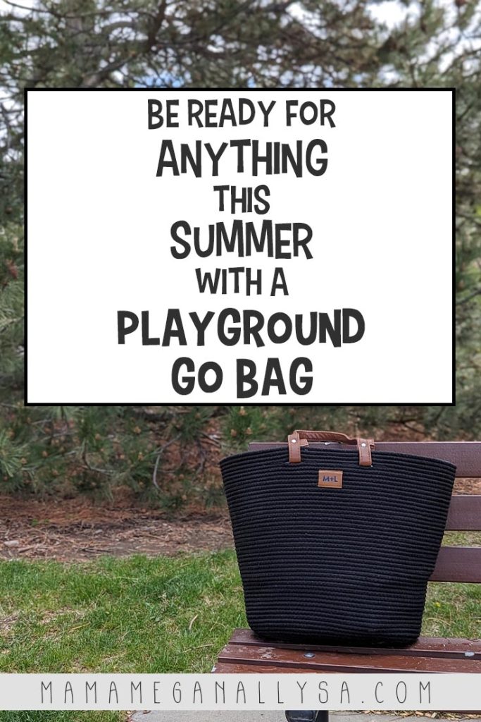 a pin image that reads be ready for anything this summer with a playground go bag in a white text box over an image of a big black rope tote bag sitting on a drown park bench with a large pine tree in the background.