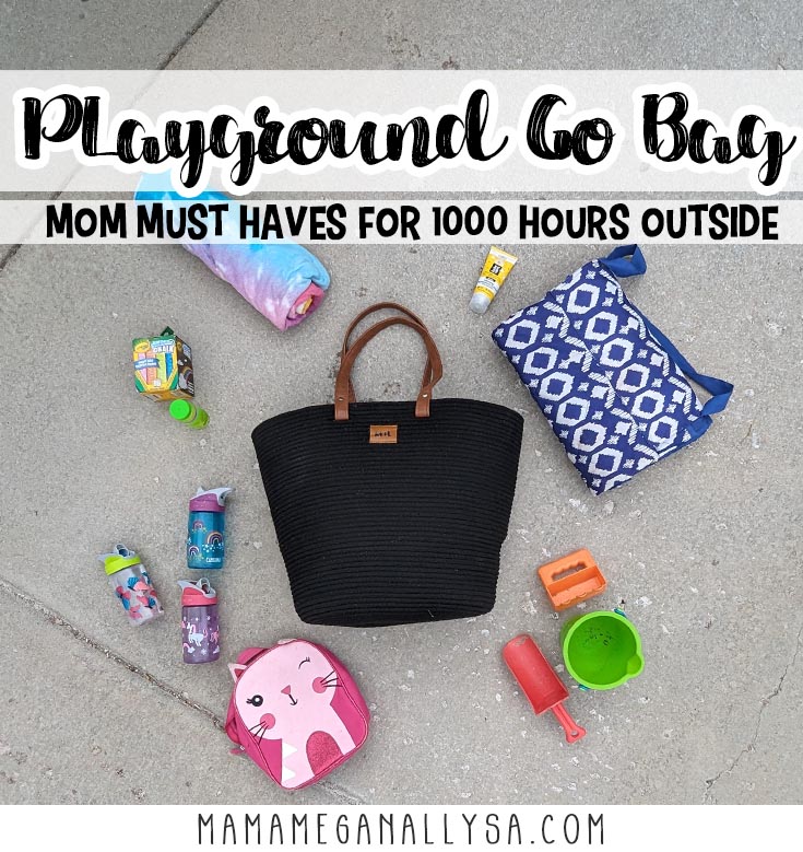 a pin image that reads playground go bag mom must haves for 1000 hours outside behind is an image of a black rope tote bag laying on the concrete with a number of items scattered around it.  the top left item is a tie-dye towl rolled up movring clockwise around the bag is a bottle of sunscreen, a blue picnic blanket, a couple of shovels and small bucket, a small pick kitty backpack three kids water bottles a small bottle of bubbles and a small box of chalk